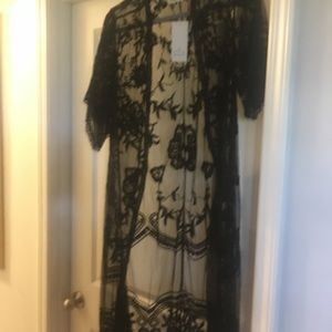 Black lace duster. Runs small, More like a medium.